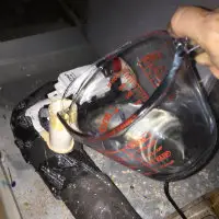 pouring vinegar into drain