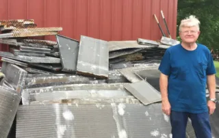 Rex Terry from Terry's A/C and Heating with a pile of coils to recycle