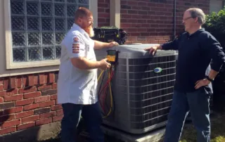Rob talking with a customer next to their outdoor condenser