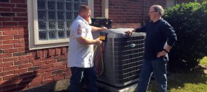 Rob talking with a customer next to their outdoor condenser