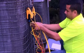 Jose checking the refrigerant charge on an outdoor condensing unit
