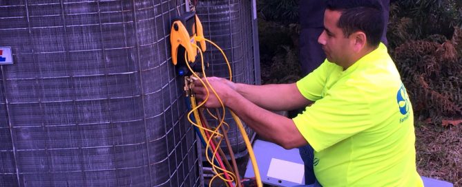 Jose checking the refrigerant charge on an outdoor condensing unit