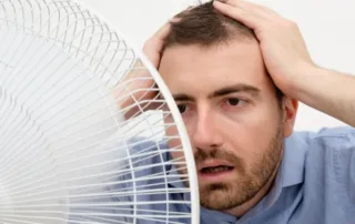 man-feeling-hot-with-a-fan