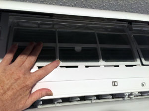 Ductless HVAC unit blower unit opened to access the air filters
