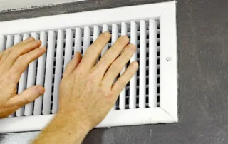 hands over an air vent