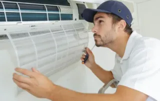 HVAC technician conducts hvac maintenance on a mini split HVAC system