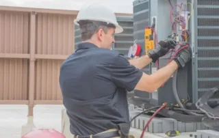 AC service technician charges air conditioner with refrigerant