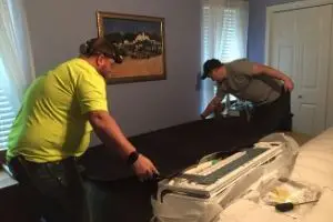 HVAC technicians spread blankets during a mini-split installation