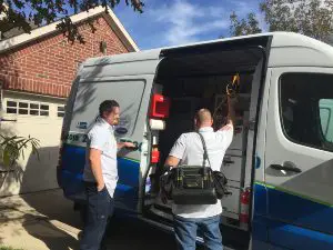 HVAC technicians getting tools out of the service truck