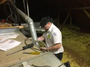 HVAC technician inspecting and maintaining a furnace