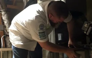 Rob Terry of Terry's A/C and Heating inspecting a furnace