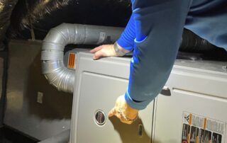 hvac-tech-rob-terry-of-terrys-ac-and-heating-working-on-a-ruud-furnace-ac-replacement-memorial-villages-neighborhood-houston-texas