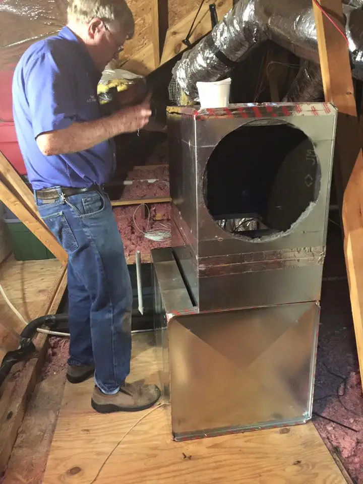 Rex Terry fixing ductwork part of a home's air delivery system.